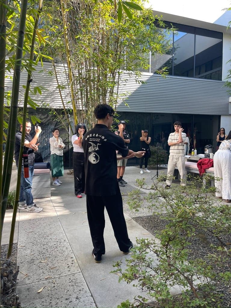 Ethan Holtzman guiding a student through a tai chi movement